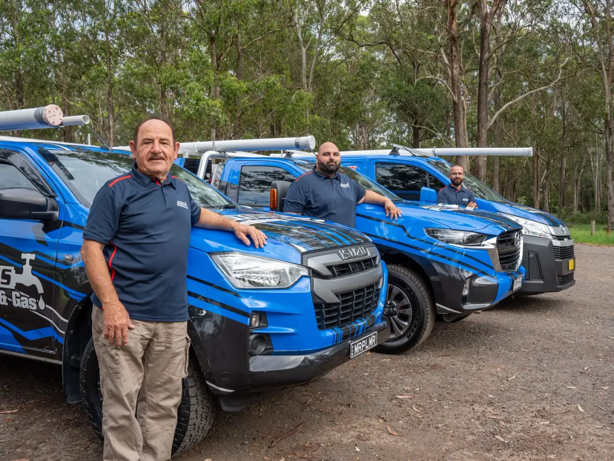 The Antons plumbing team with their fleet of service vehicles